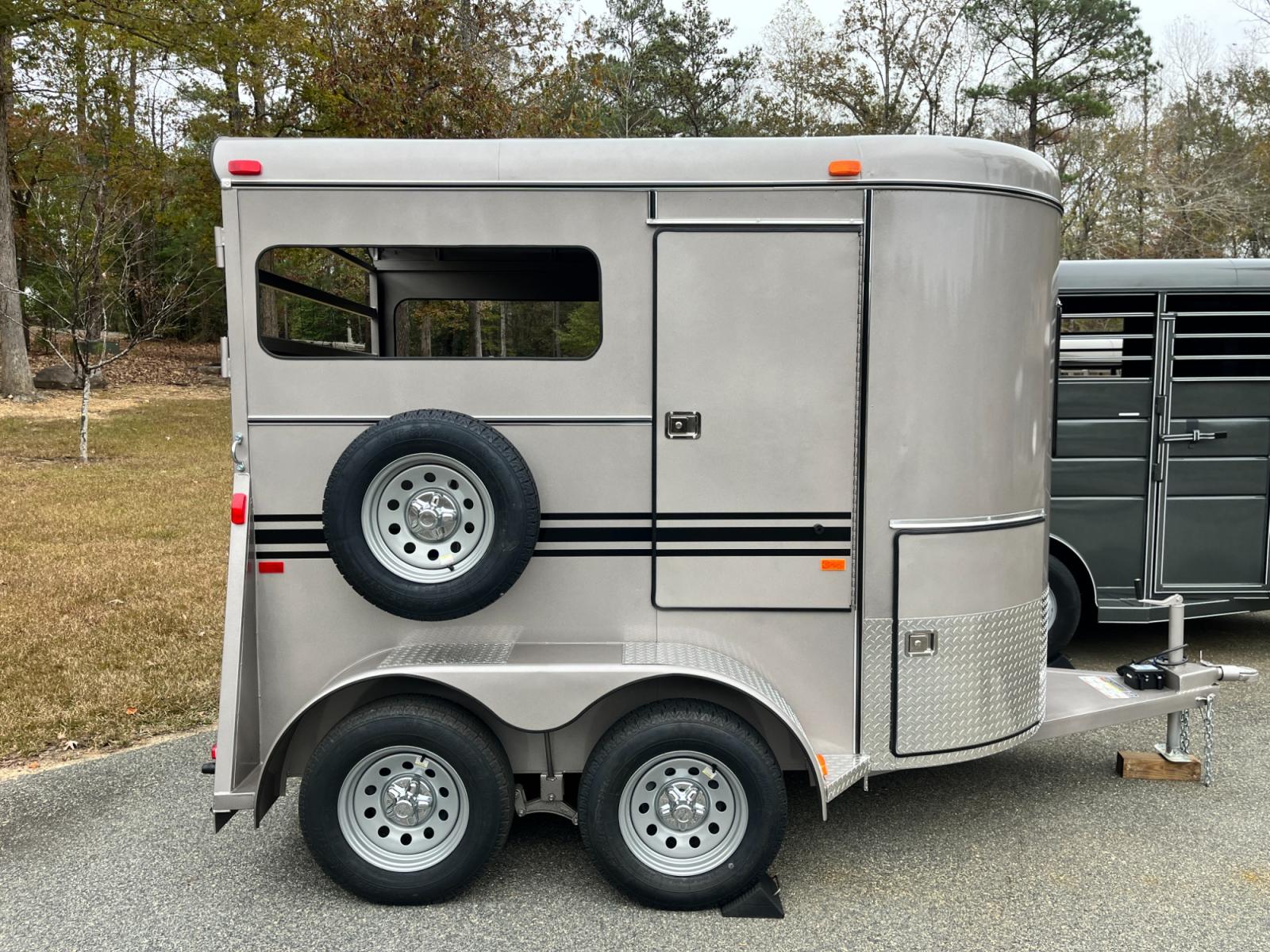2023 Pewter Metallic Bee Trailers 2 Horse Straight Load Wrangler , located at 1330 Rainey Rd., Macon, 31220, (478) 960-1044, 32.845638, -83.778687 - Brand New Bee Brand 2 Horse Straight Load Wrangler Series Trailer. Super Deluxe 6ft X 10ft Outside Model is 7ft Tall for Larger Horses too! Made Using Rust Resistant Galvanneal Steel Made in USA! Escape Door and Huge Tack Area, w/Sliding Saddle Rack! Tandem 3,500lb Spring Axles, Both Have Electr - Photo #1